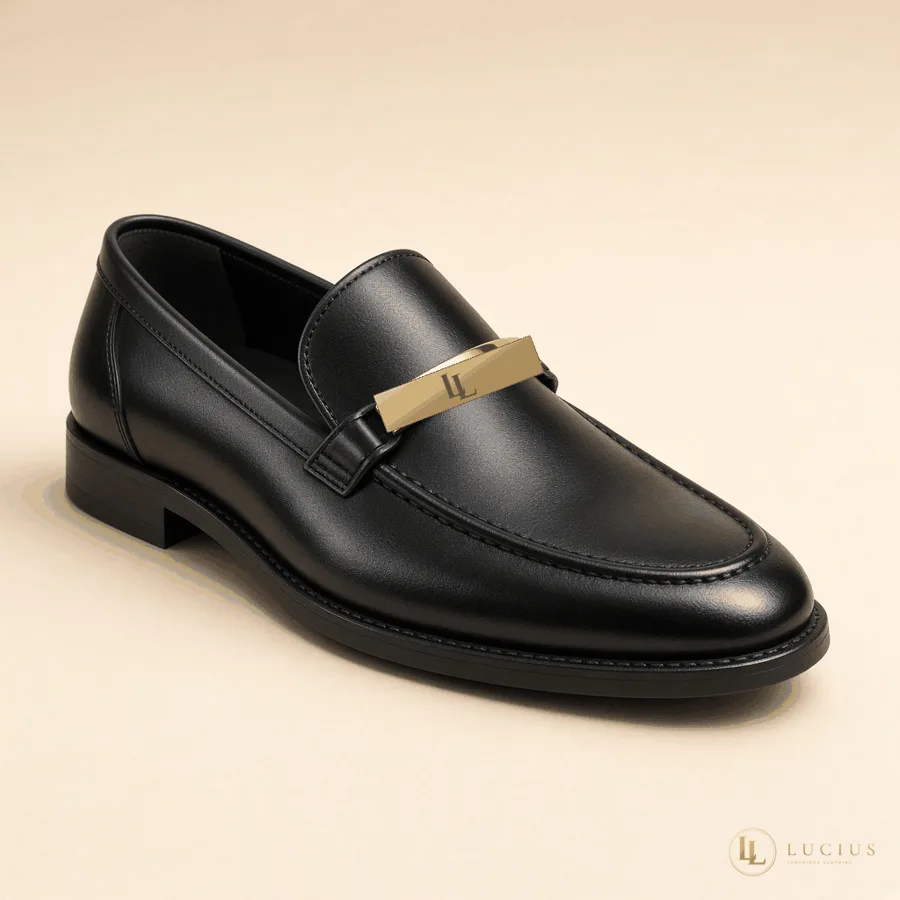 Black leather loafer with a gold bar